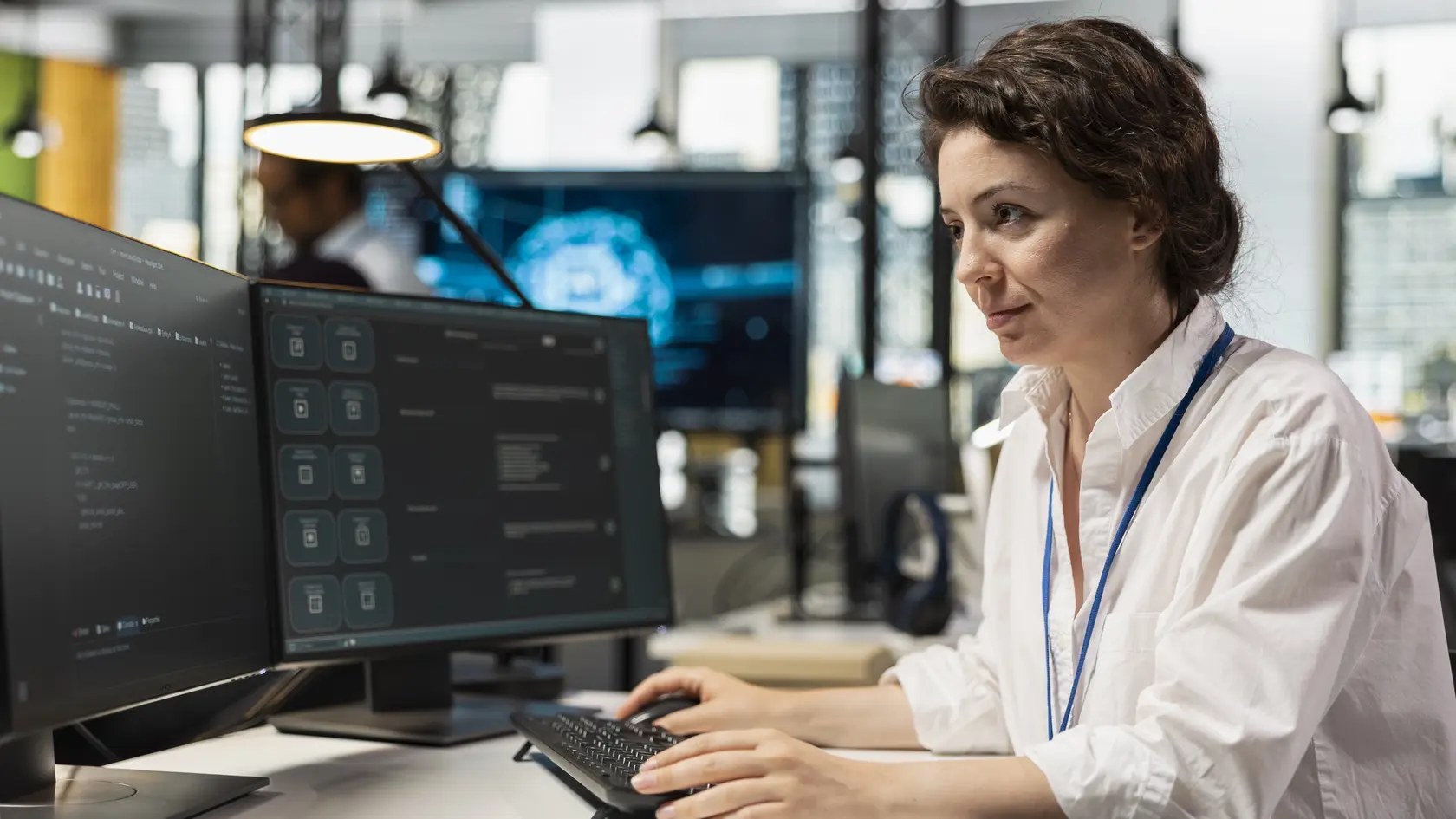Computer scientist running AI large language model chatbot on PC in startup workspace. IT professional using artificial intelligence neural network LLM coding platform on computer